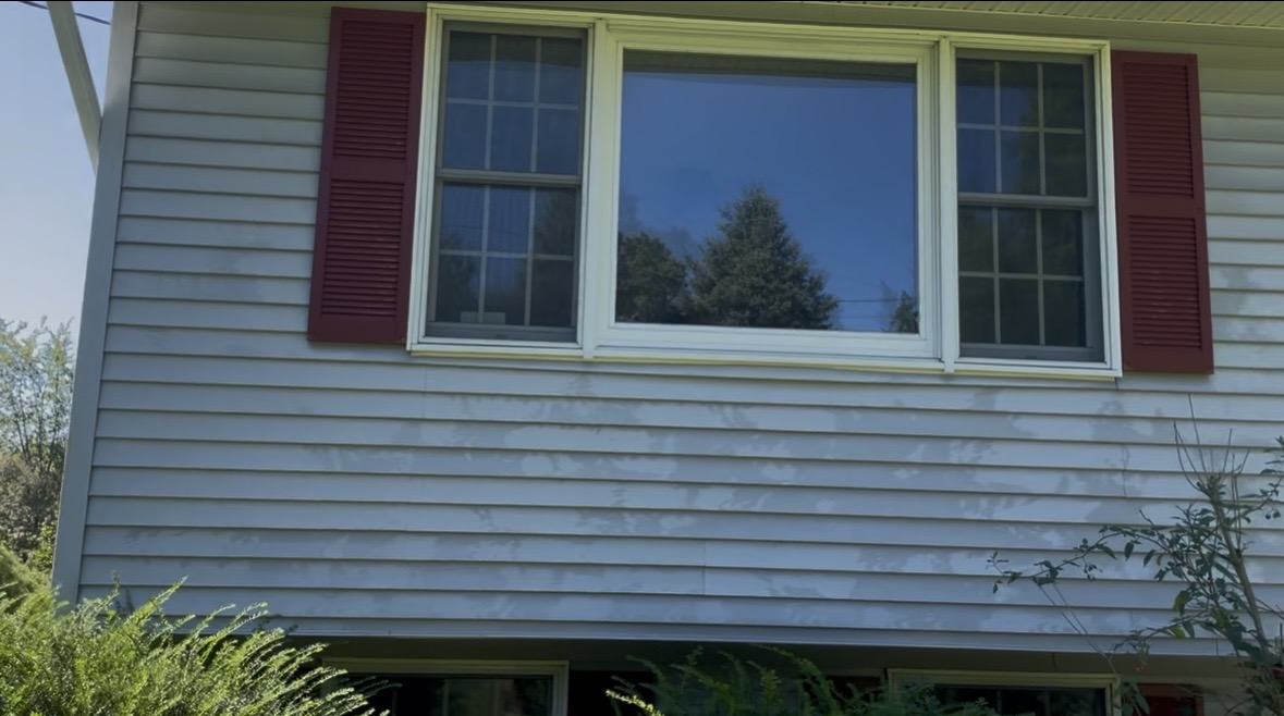 Clean house siding after soft wash treatment